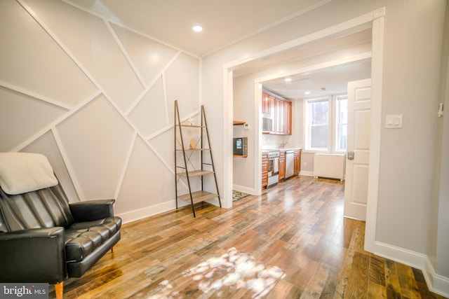 sitting room featuring wood finished floors, baseboards, and recessed lighting