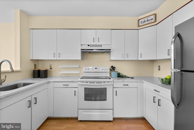 7617 Stony Creek Ln, Ellicott City, MD 21043 - kitchen featuring electric stove, freestanding refrigerator, ventilation hood, a sink, and light countertops