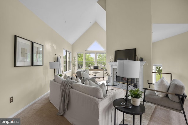 7617 Stony Creek Ln, Ellicott City, MD 21043 - carpeted living room featuring high vaulted ceiling, baseboards, a tiled fireplace, and plenty of natural light