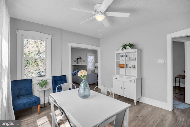 727 Willitts Ave, Audubon, NJ 08106 - dining room with plenty of natural light, wood finished floors, a textured ceiling, a ceiling fan, and baseboards