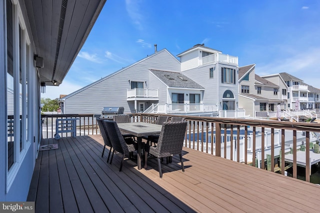 deck with a residential view and outdoor dining space