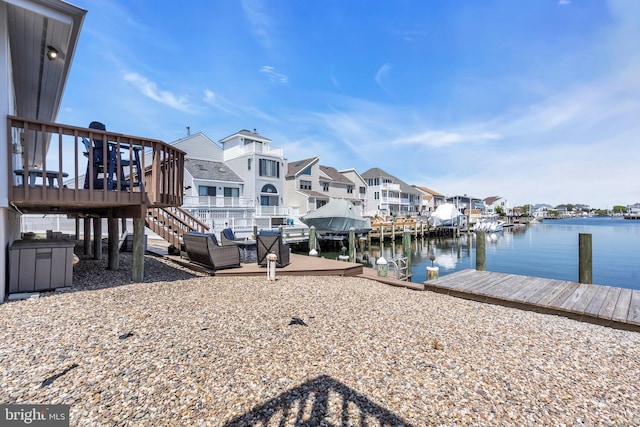 dock featuring a residential view, a water view, and stairs