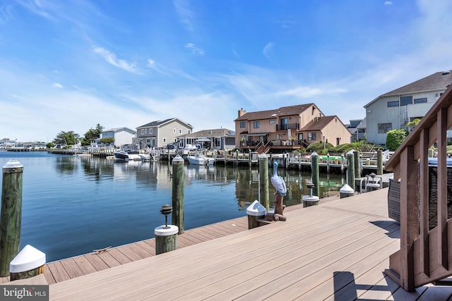 dock area with a water view and a residential view
