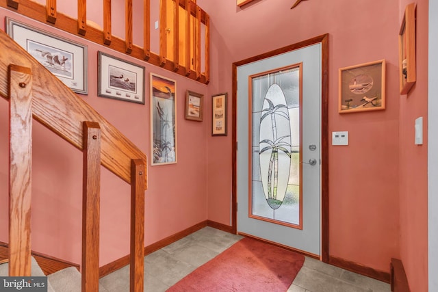 entryway featuring baseboards, plenty of natural light, and tile patterned floors