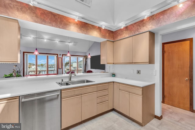 kitchen with dishwasher, a sink, light countertops, hanging light fixtures, and cream cabinets