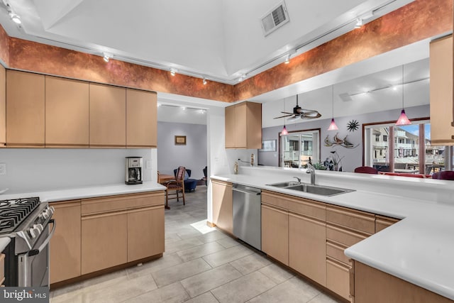 kitchen with appliances with stainless steel finishes, a sink, light countertops, pendant lighting, and a ceiling fan