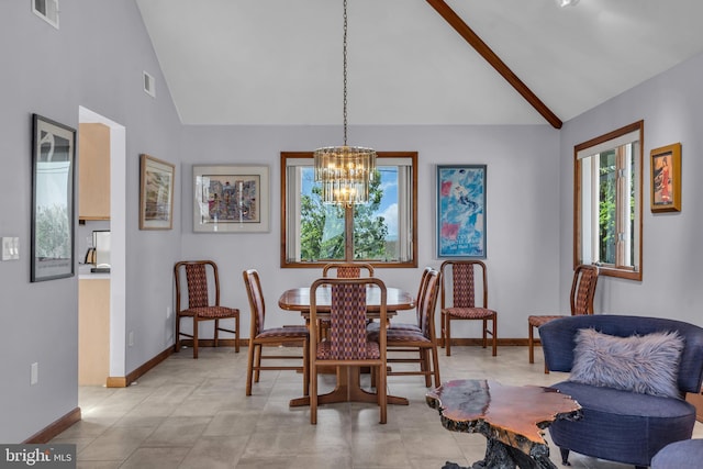 dining space with a chandelier, high vaulted ceiling, and baseboards