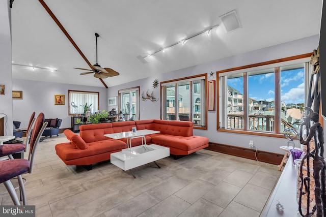 living area featuring ceiling fan, healthy amount of natural light, and rail lighting