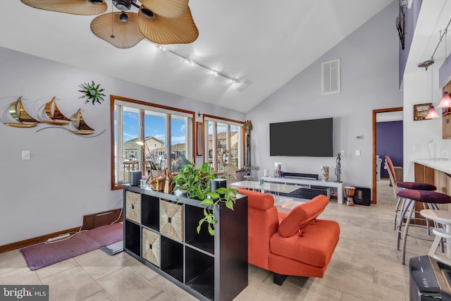 living area with track lighting, ceiling fan, baseboards, and high vaulted ceiling