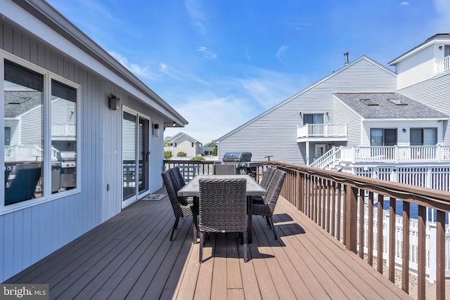 wooden terrace with outdoor dining area