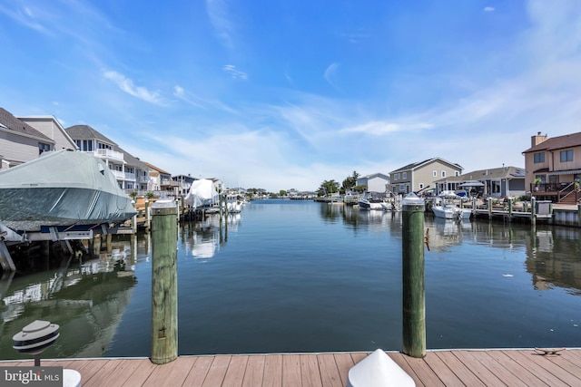 dock area featuring a water view, a residential view, and boat lift
