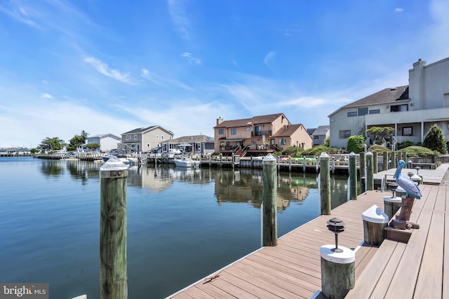 dock featuring a water view and a residential view