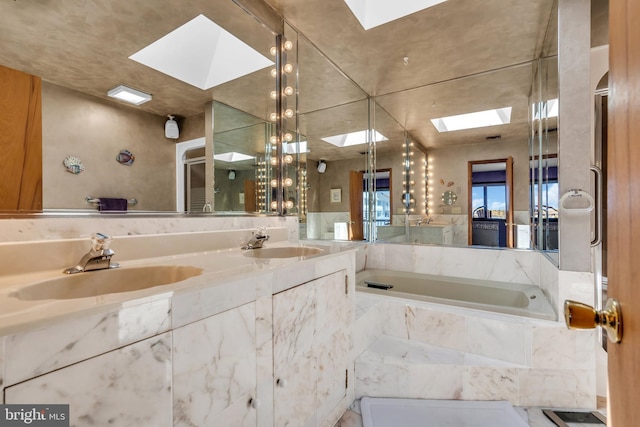 full bathroom featuring a skylight, a garden tub, and double vanity