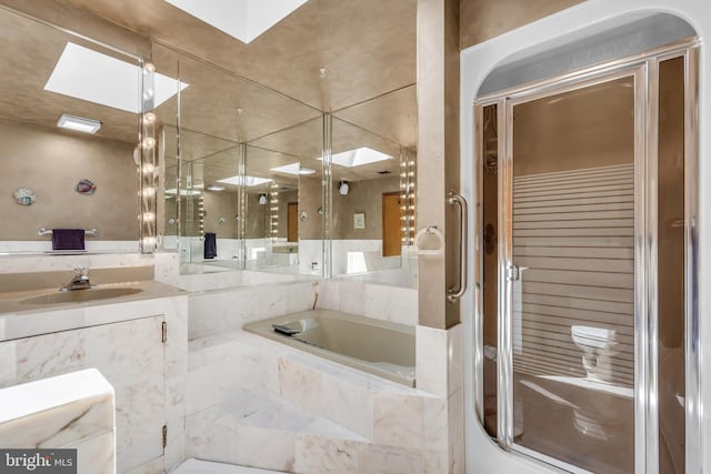full bathroom with a shower stall, vanity, and a bath