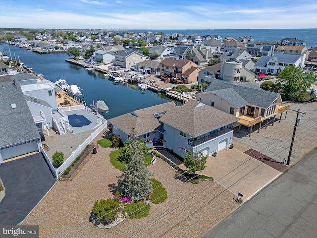 aerial view of residential area featuring a nearby body of water