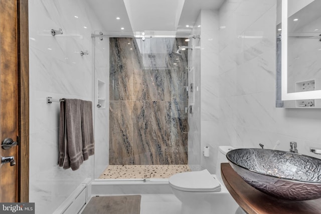 full bath featuring a marble finish shower, tile walls, toilet, a sink, and recessed lighting