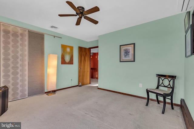 unfurnished room featuring a baseboard radiator, ceiling fan, light colored carpet, and baseboards