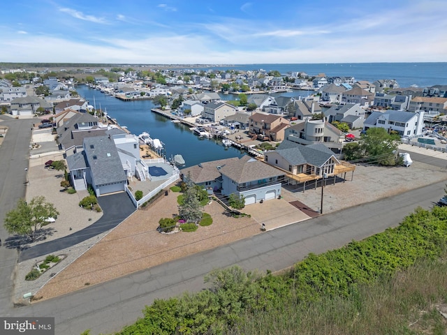 aerial view of residential area featuring a large body of water