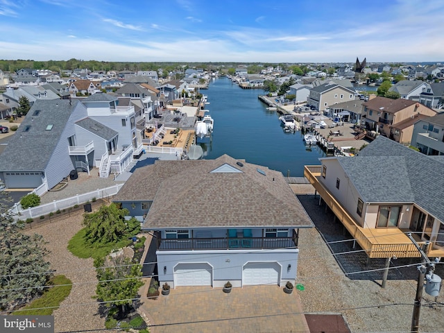 aerial view of residential area featuring a large body of water