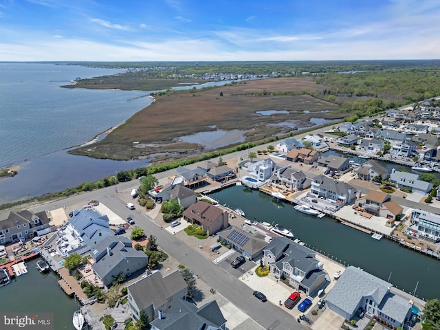 aerial view of residential area featuring a large body of water
