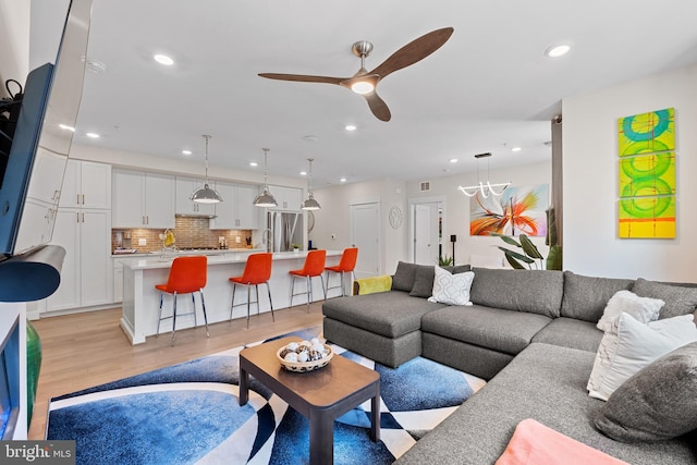 23650 Havelock Walk Ter Unit 303, Ashburn, VA 20148 - living room featuring a ceiling fan, light wood-style floors, and recessed lighting