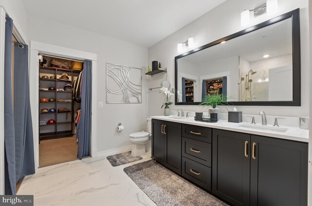 23650 Havelock Walk Ter Unit 303, Ashburn, VA 20148 - full bath featuring a stall shower, a spacious closet, double vanity, marble finish flooring, and toilet