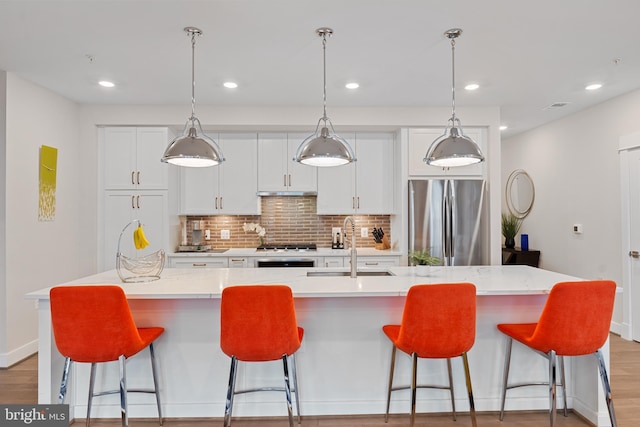 23650 Havelock Walk Ter Unit 303, Ashburn, VA 20148 - kitchen featuring freestanding refrigerator, a sink, tasteful backsplash, recessed lighting, and white cabinetry