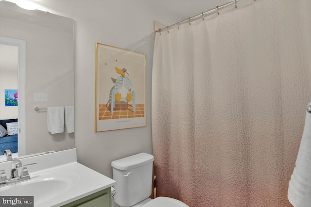 full bathroom featuring vanity and toilet