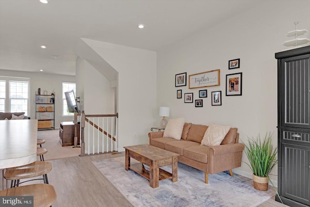living area with light wood-style flooring and recessed lighting