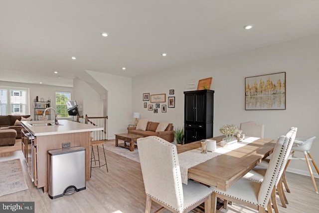 dining room with light wood-style floors and recessed lighting