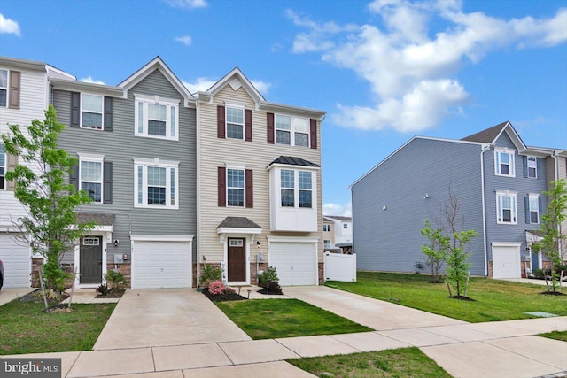 multi unit property with concrete driveway, a front lawn, and a garage