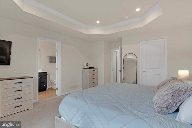 bedroom with a tray ceiling, light carpet, and recessed lighting