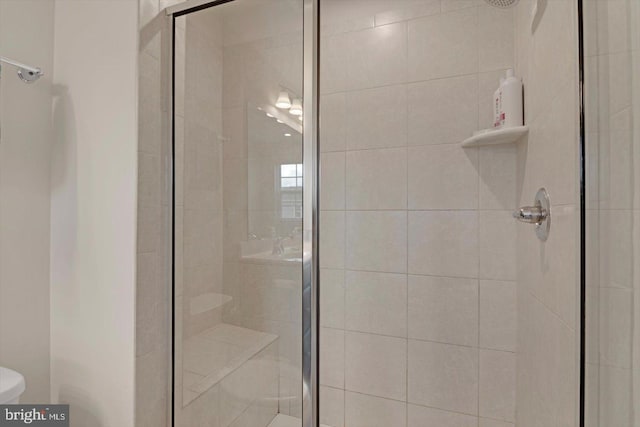 full bath with toilet and a stall shower