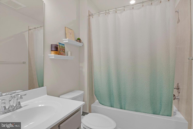 bathroom featuring toilet, shower / tub combo, and vanity