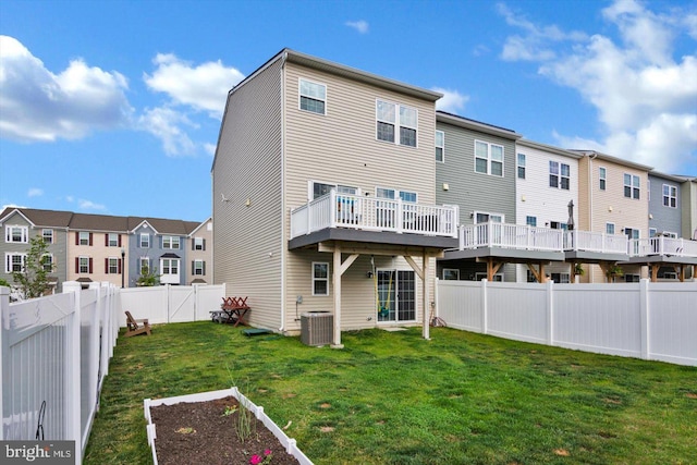 back of property with central AC, a residential view, a deck, and a vegetable garden