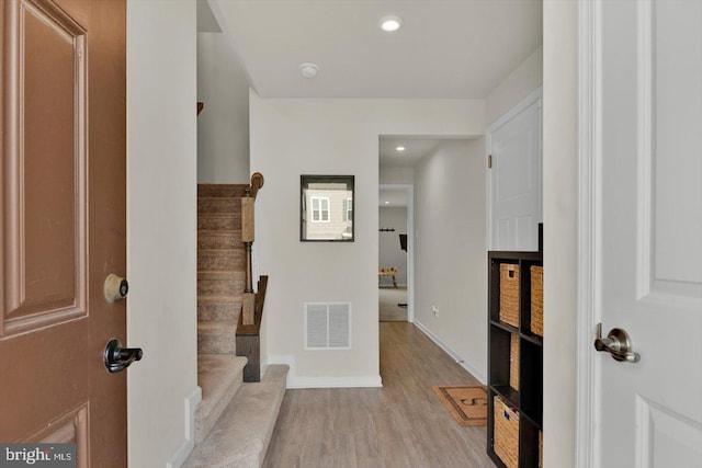 foyer entrance featuring stairway, light wood finished floors, recessed lighting, and baseboards