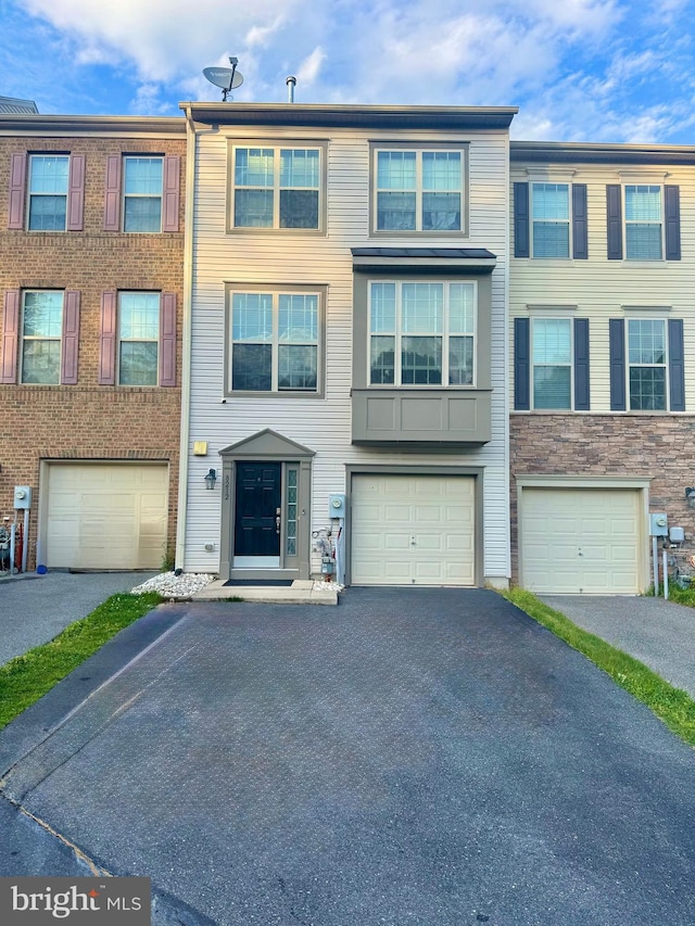 view of property featuring a garage and driveway