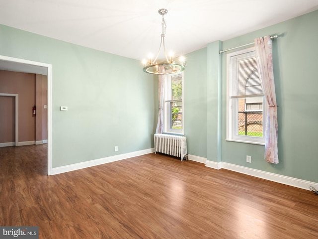 556 W Walnut St, Pottstown, PA 19464 - spare room with radiator, a chandelier, wood finished floors, and baseboards