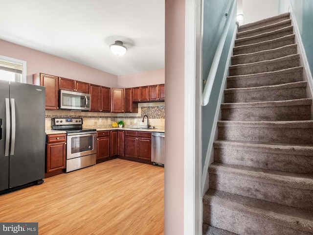 556 W Walnut St, Pottstown, PA 19464 - kitchen featuring stainless steel appliances, a sink, light countertops, and light wood-style flooring