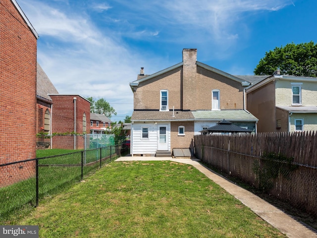 556 W Walnut St, Pottstown, PA 19464 - rear view of property with entry steps and a chimney