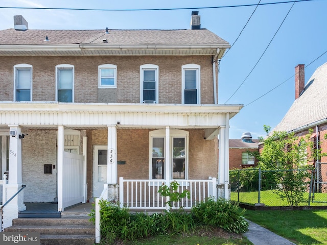 556 W Walnut St, Pottstown, PA 19464 - view of front of house with covered porch, fence, roof with shingles, and a chimney