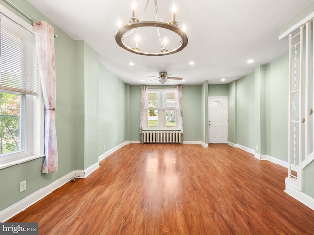 556 W Walnut St, Pottstown, PA 19464 - spare room featuring radiator heating unit, a chandelier, wood finished floors, baseboards, and recessed lighting