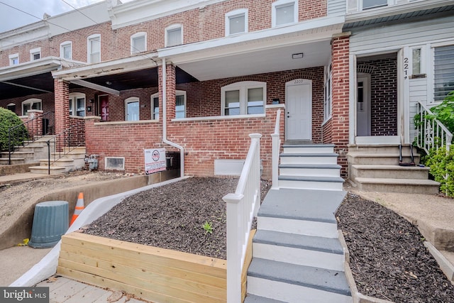 doorway to property featuring brick siding