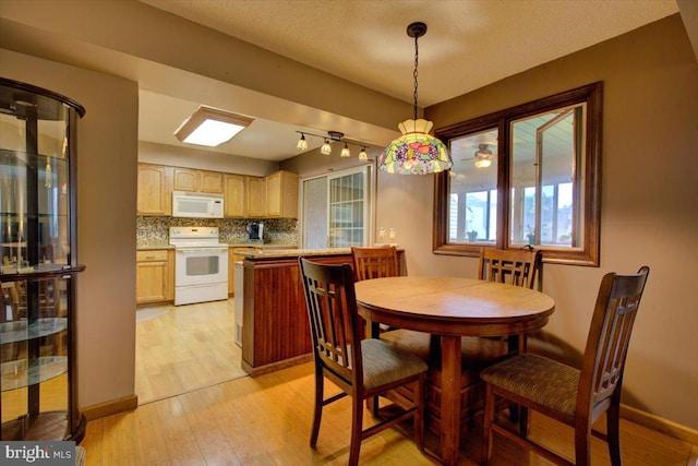 102 Harvest Ln Unit 207, Phoenixville, PA 19460 - dining room with light wood-style floors and baseboards