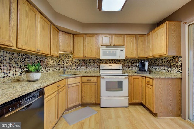 102 Harvest Ln Unit 207, Phoenixville, PA 19460 - kitchen with white appliances, a sink, light wood-style flooring, light stone countertops, and backsplash
