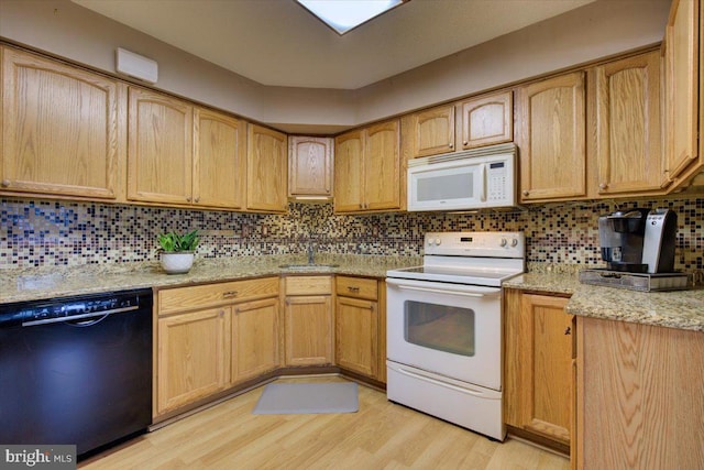 102 Harvest Ln Unit 207, Phoenixville, PA 19460 - kitchen featuring white appliances, a sink, light wood finished floors, and decorative backsplash