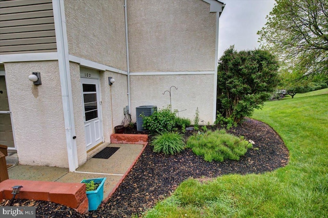 102 Harvest Ln Unit 207, Phoenixville, PA 19460 - view of side of property featuring central air condition unit, a lawn, and stucco siding
