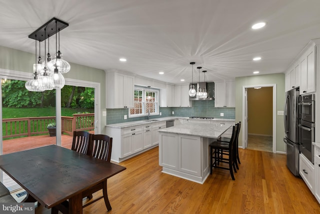 7071 Garden Walk, Columbia, MD 21044 - kitchen with stainless steel appliances, a center island, white cabinets, tasteful backsplash, and a sink