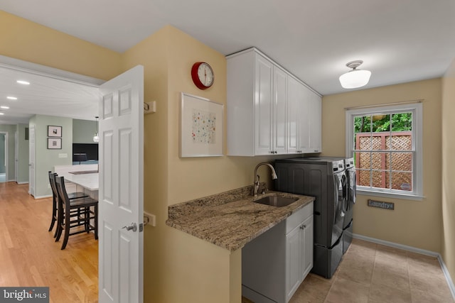 7071 Garden Walk, Columbia, MD 21044 - washroom featuring washing machine and dryer, cabinet space, and baseboards