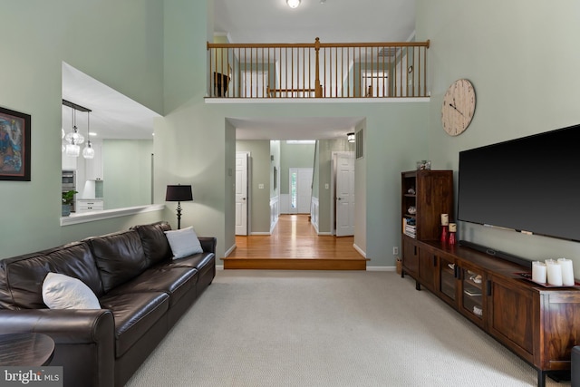 7071 Garden Walk, Columbia, MD 21044 - carpeted living room featuring a high ceiling and baseboards
